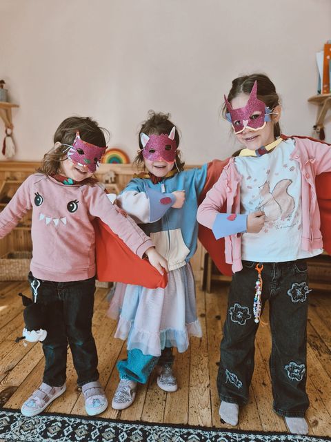 Three children wearing capes they made